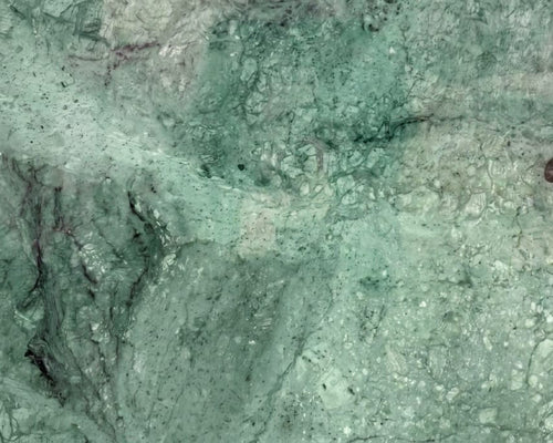 Close-up of greenish-brown stone surface with visible texture.